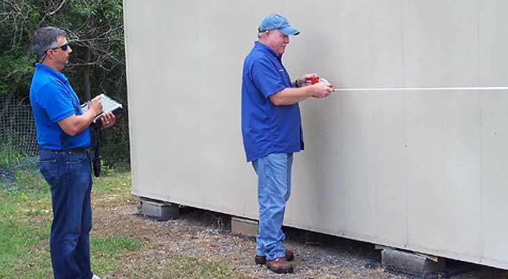 Two men beside building